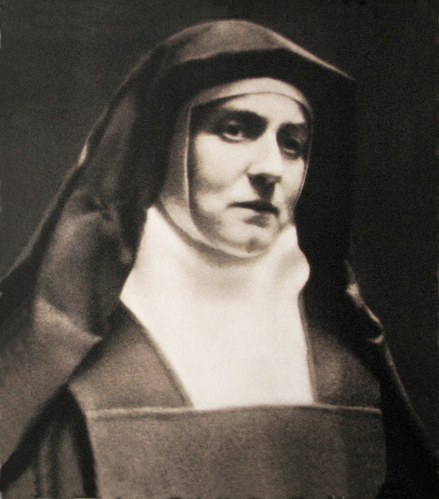 Black and white portrait photograph of a woman in a Carmelite nun's veil and habit, looking slightly to one side