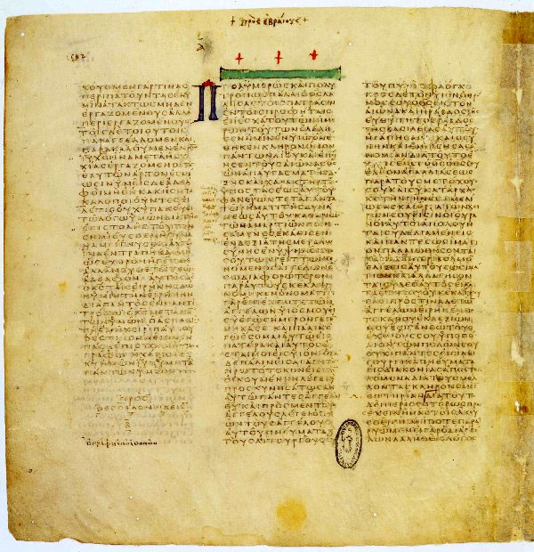 A parchment page in three columns of brownish Greek capital letters, with a decorated band and a heading where a new book begins in the third column