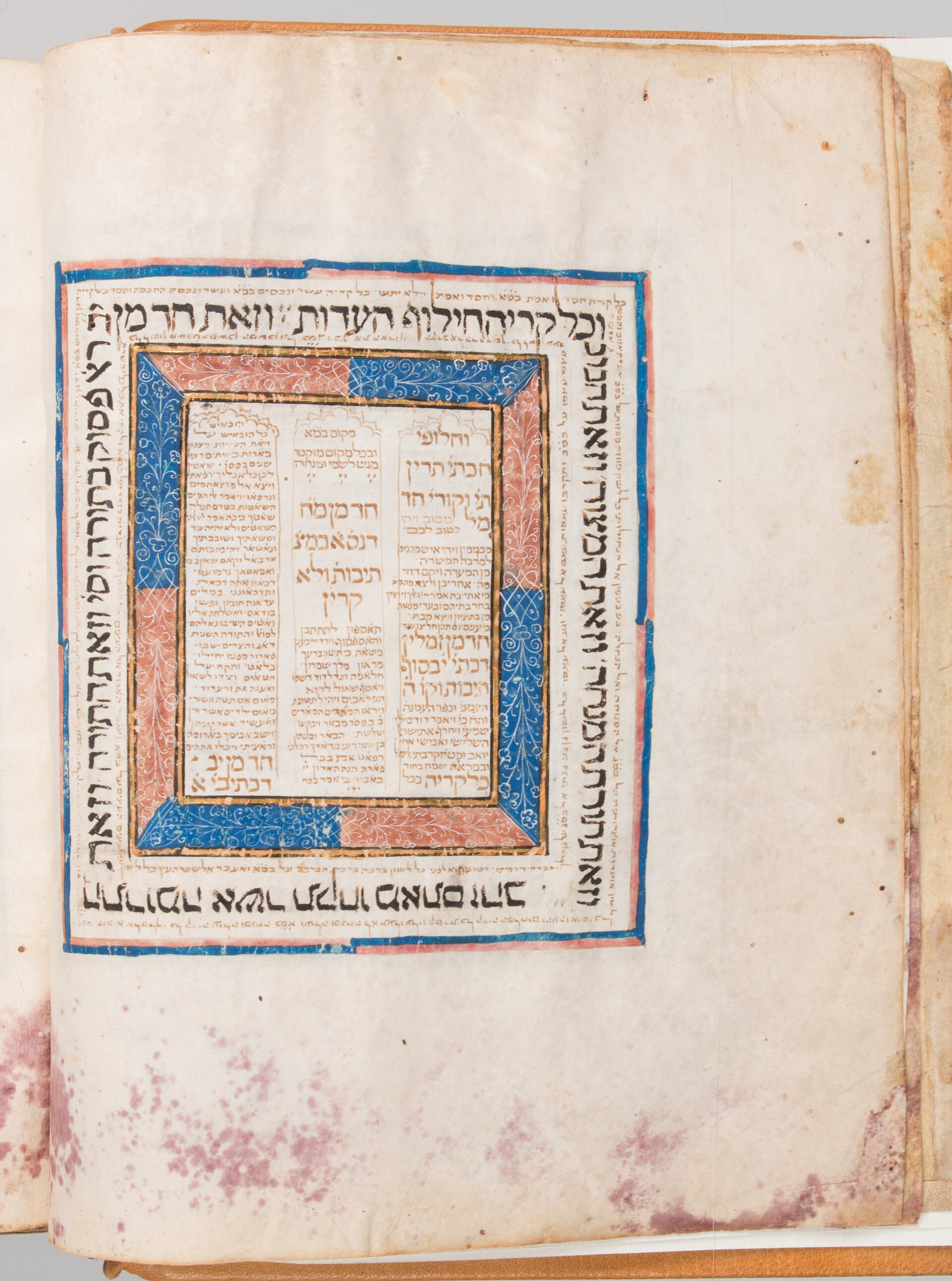 A page from a medieval Hebrew Bible written in square Hebrew letters in columns, with small decorated ornaments in the margins