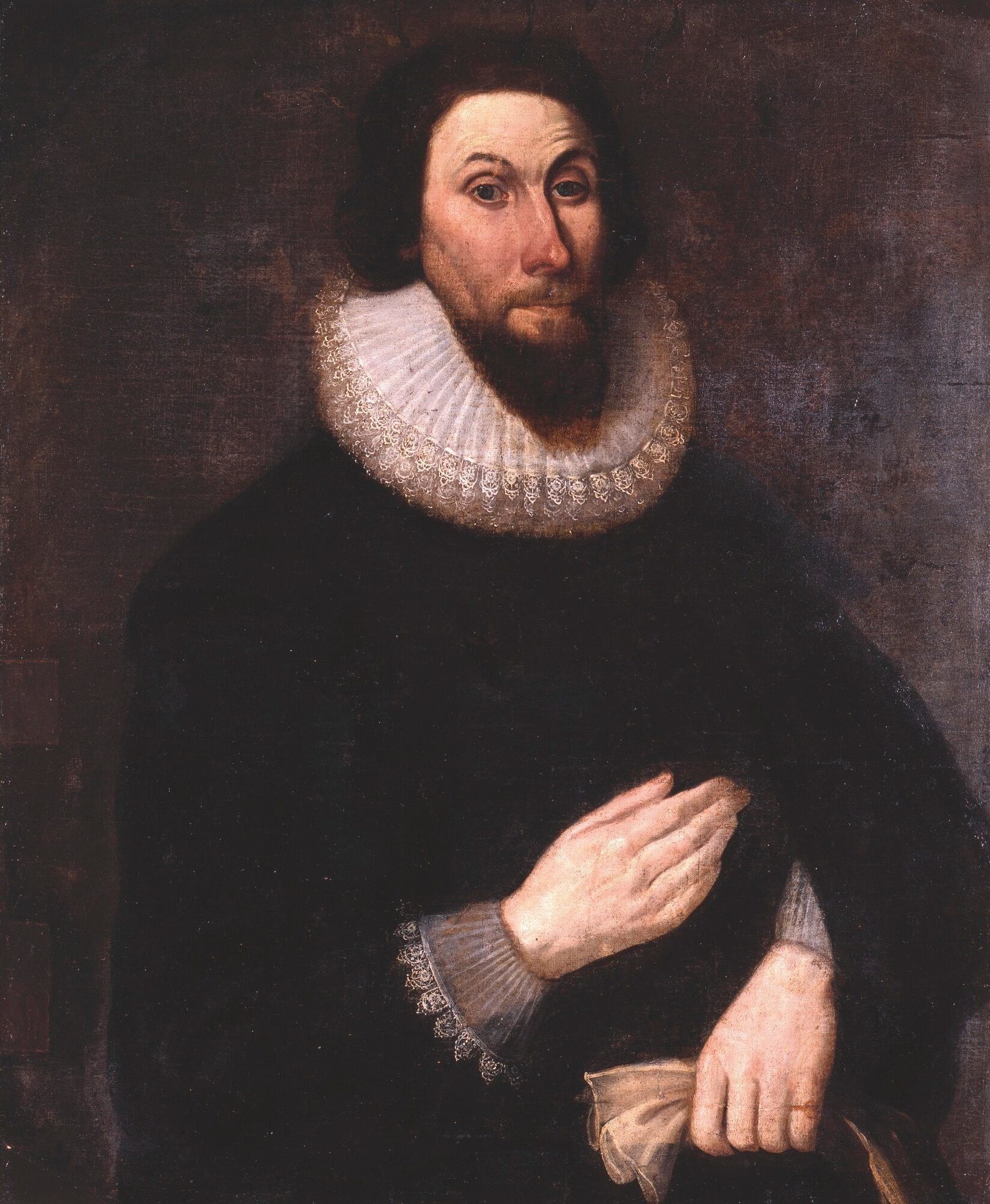Oil portrait of a bearded man with a large white ruff collar and dark clothing against a dark background