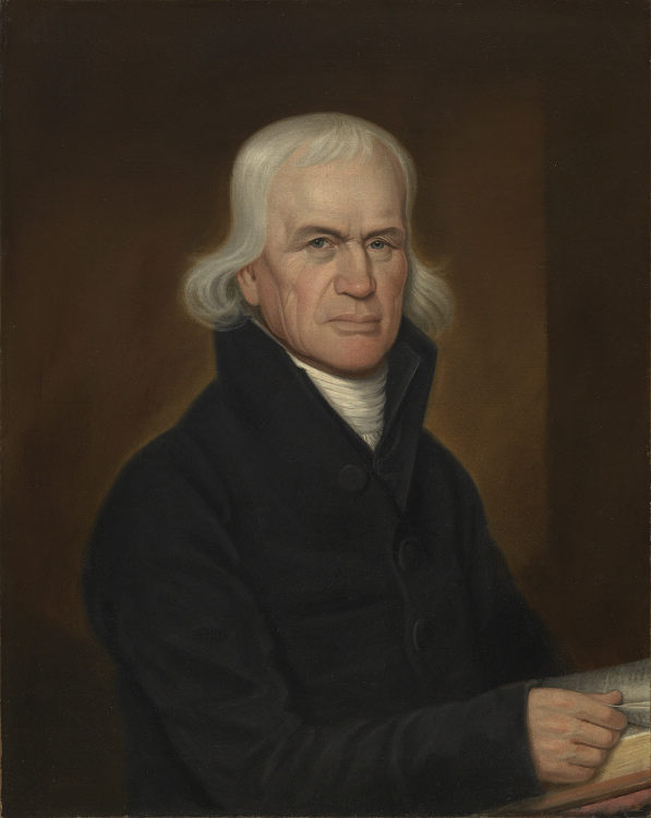 Oil portrait of an elderly clergyman with white hair falling to his collar, in a dark coat with white neckcloth, seated against a plain background