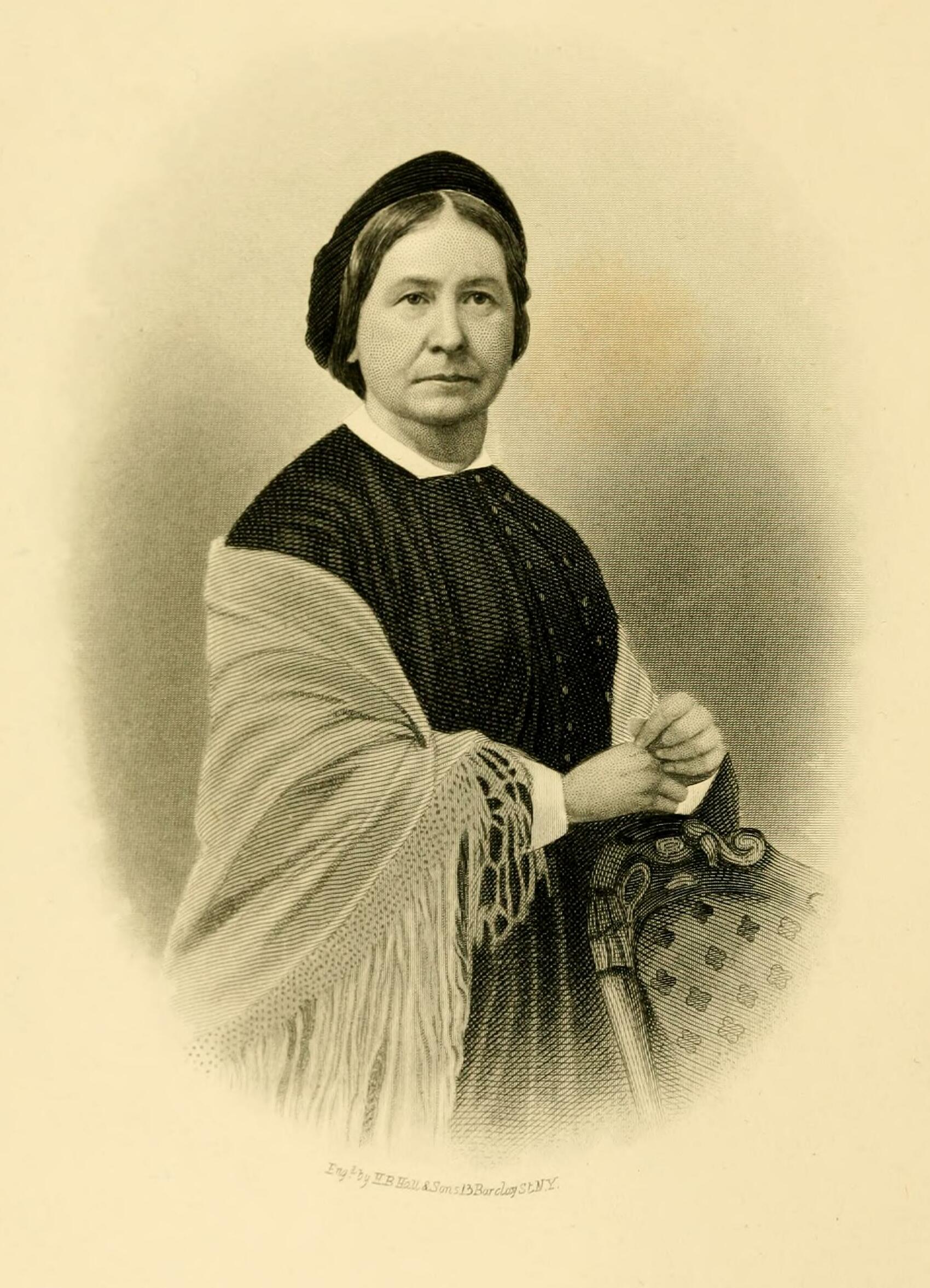 Engraved oval portrait of a woman in a dark dress and dark head covering, with a fringed shawl over one arm and her hands folded on the back of a carved chair