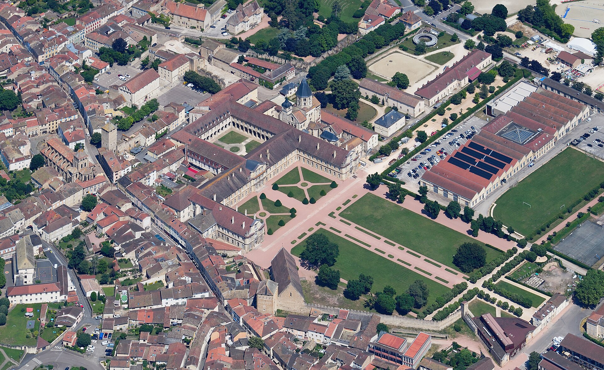 Aerial photograph of the surviving abbey buildings and church tower of Cluny among the roofs of the town