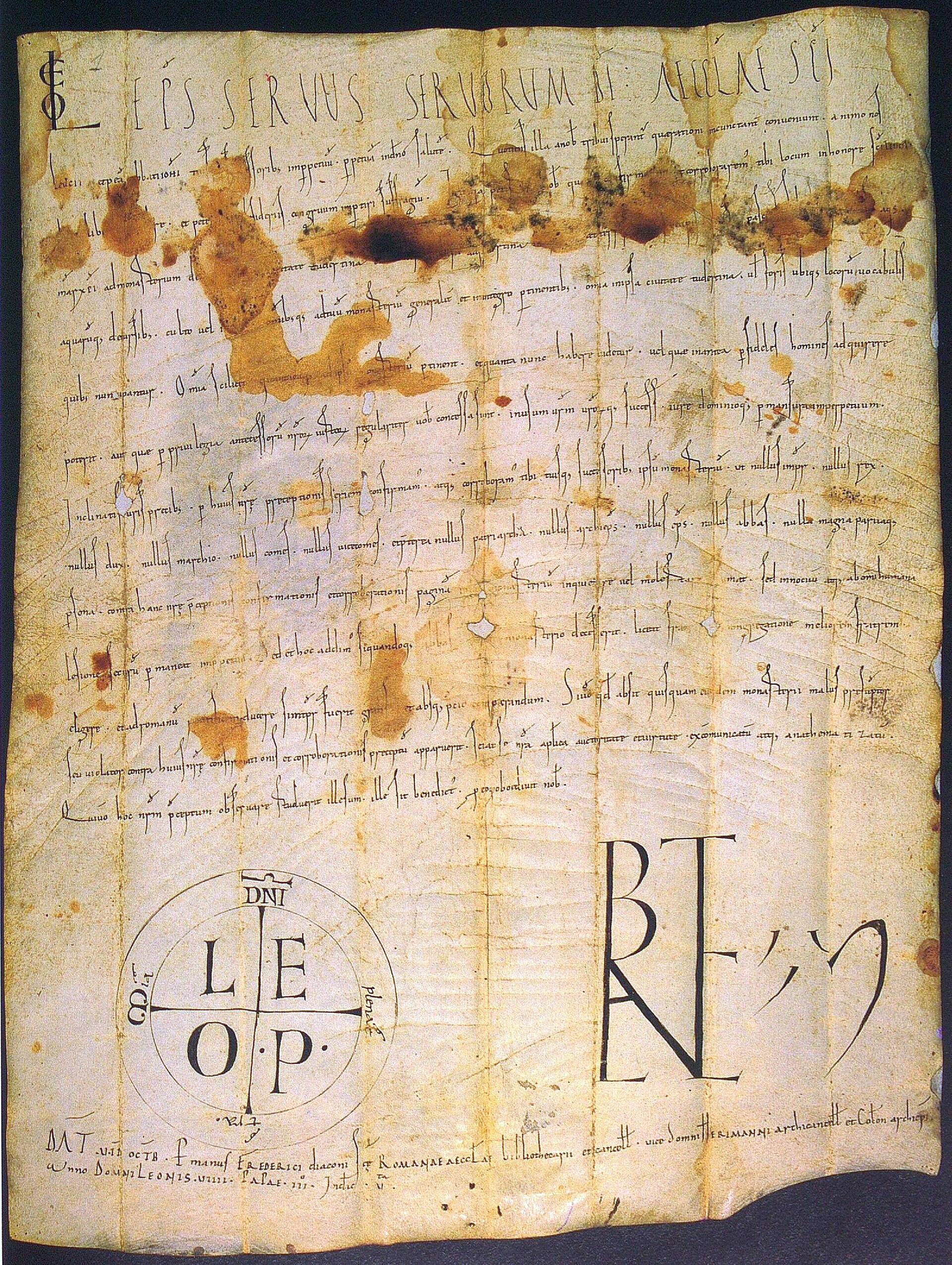 A large sheet of medieval parchment covered in dense Latin script, with a round papal sign and signature marks near the bottom