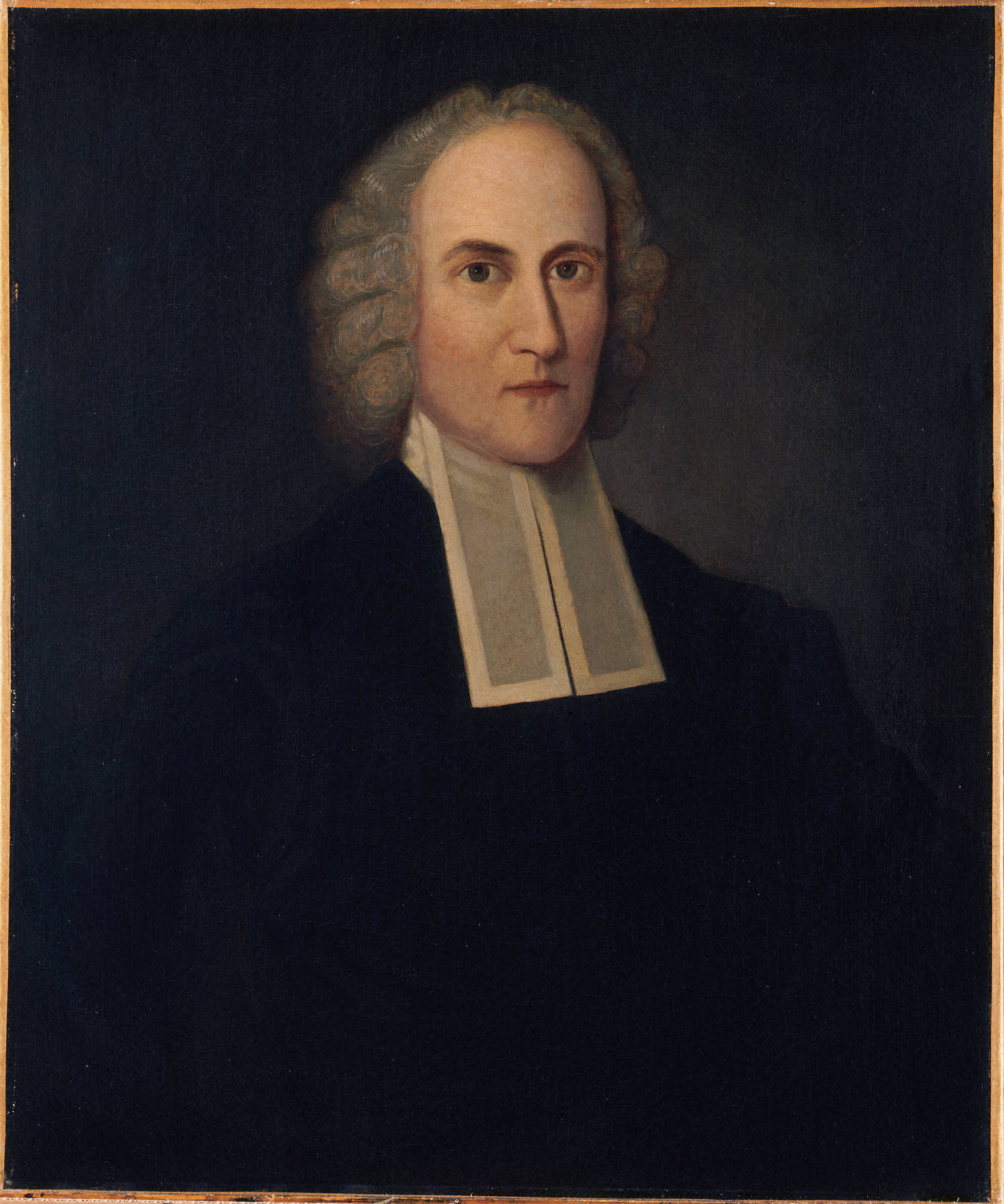 Portrait of a man in a black gown with white clerical bands and a powdered wig, seated against a dark background