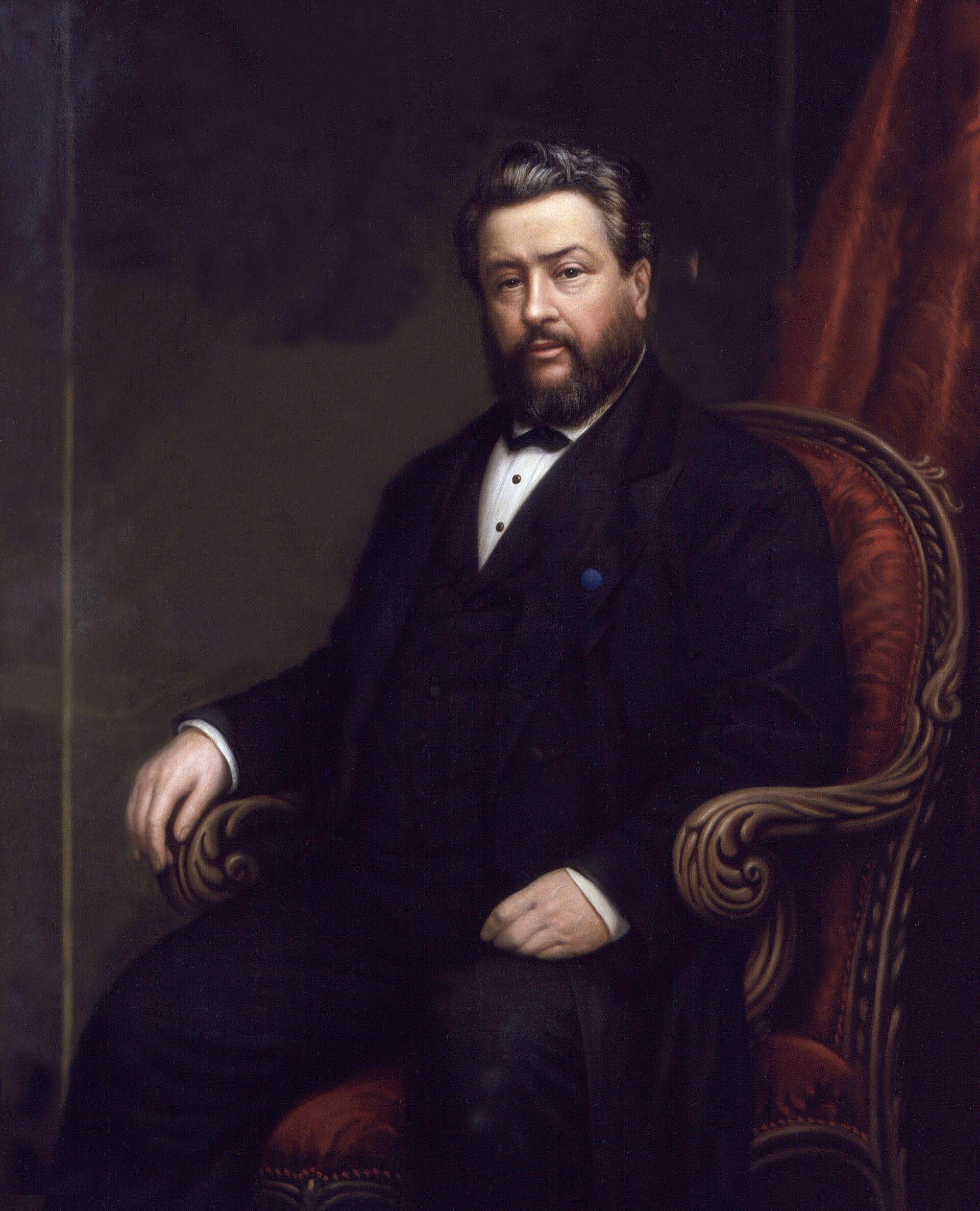 A painted portrait of Charles Haddon Spurgeon, a bearded man in a dark suit, seated, holding a book