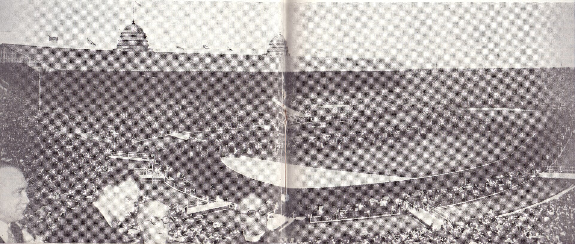 A wide black and white photograph of a packed stadium crowd facing a platform during Billy Graham's 1954 London meetings