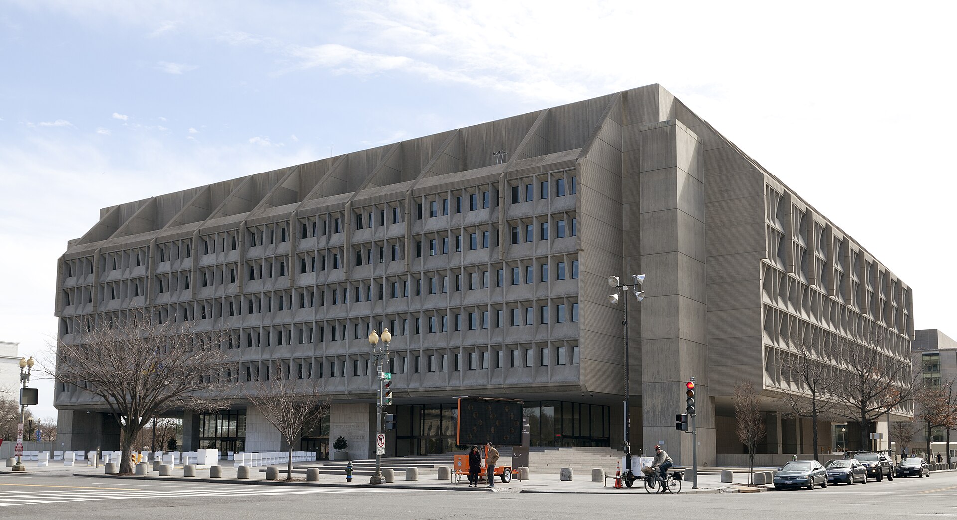 The Hubert H. Humphrey Building, a large concrete office building with a recessed upper section, at the foot of Capitol Hill in Washington, D.C.