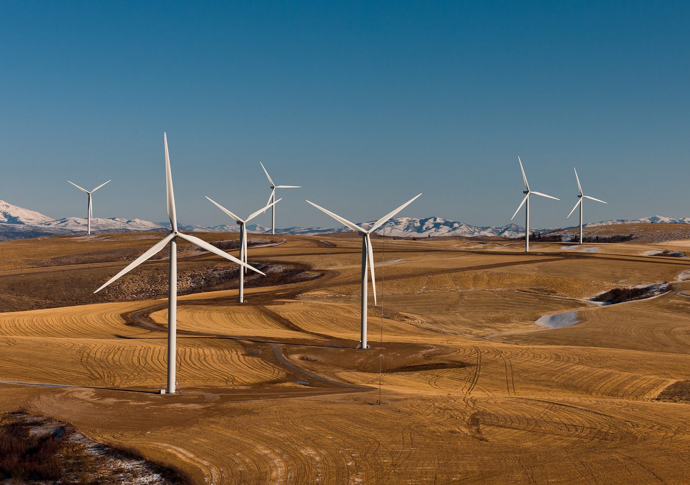 Aerial view of wind turbines spread across open farm and range land in Power County, Idaho