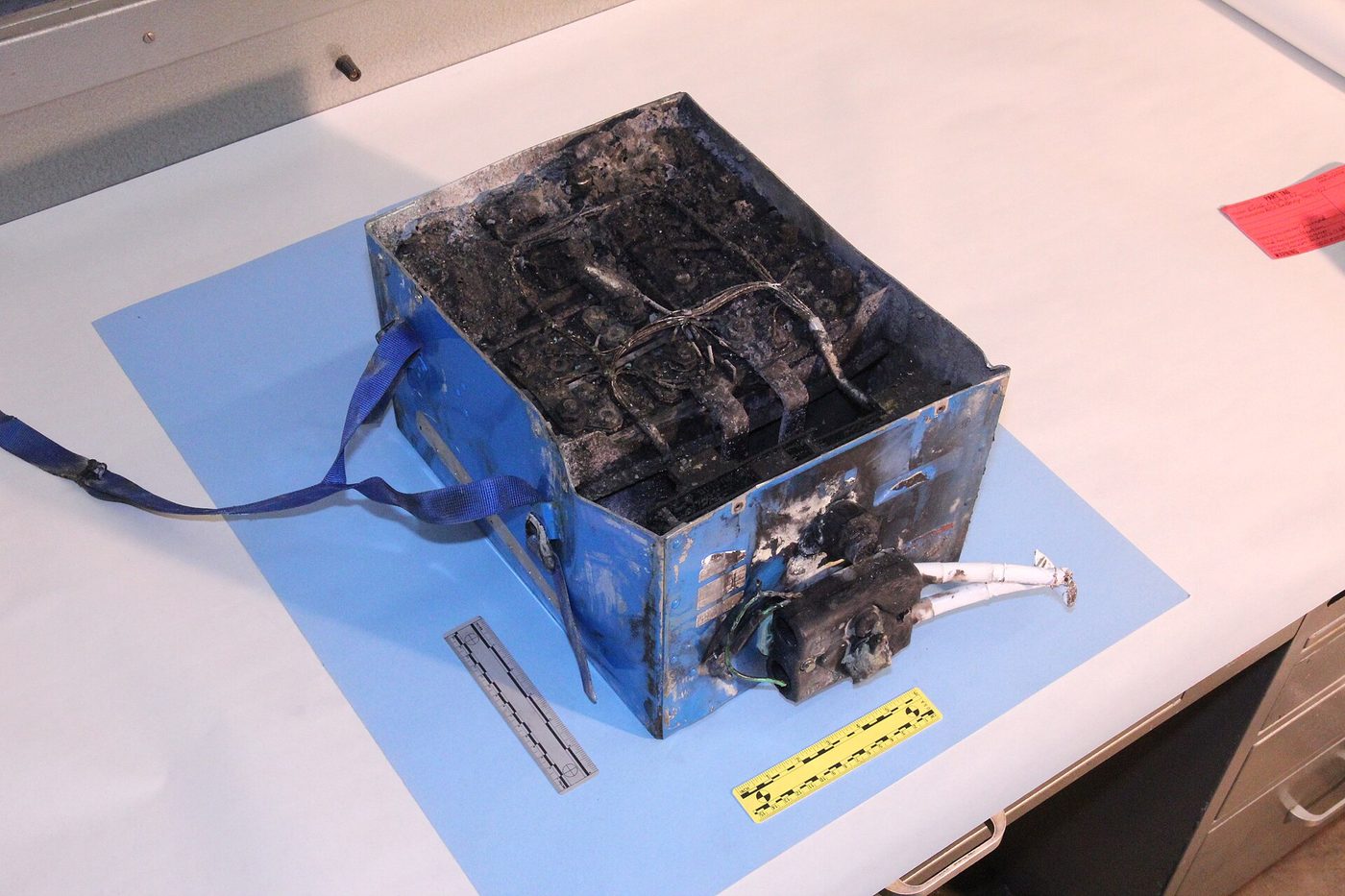 Burned and blackened lithium-ion battery case from a Boeing 787 auxiliary power unit, photographed by federal investigators