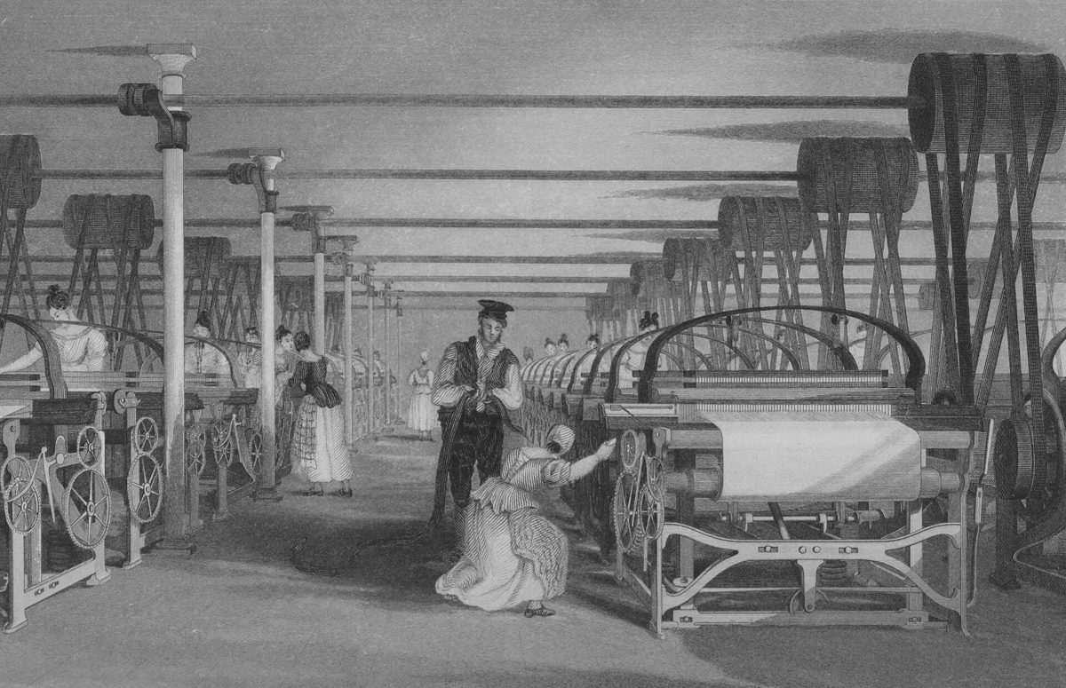 Nineteenth-century print of rows of power looms in a long weaving shed, with workers tending the machines