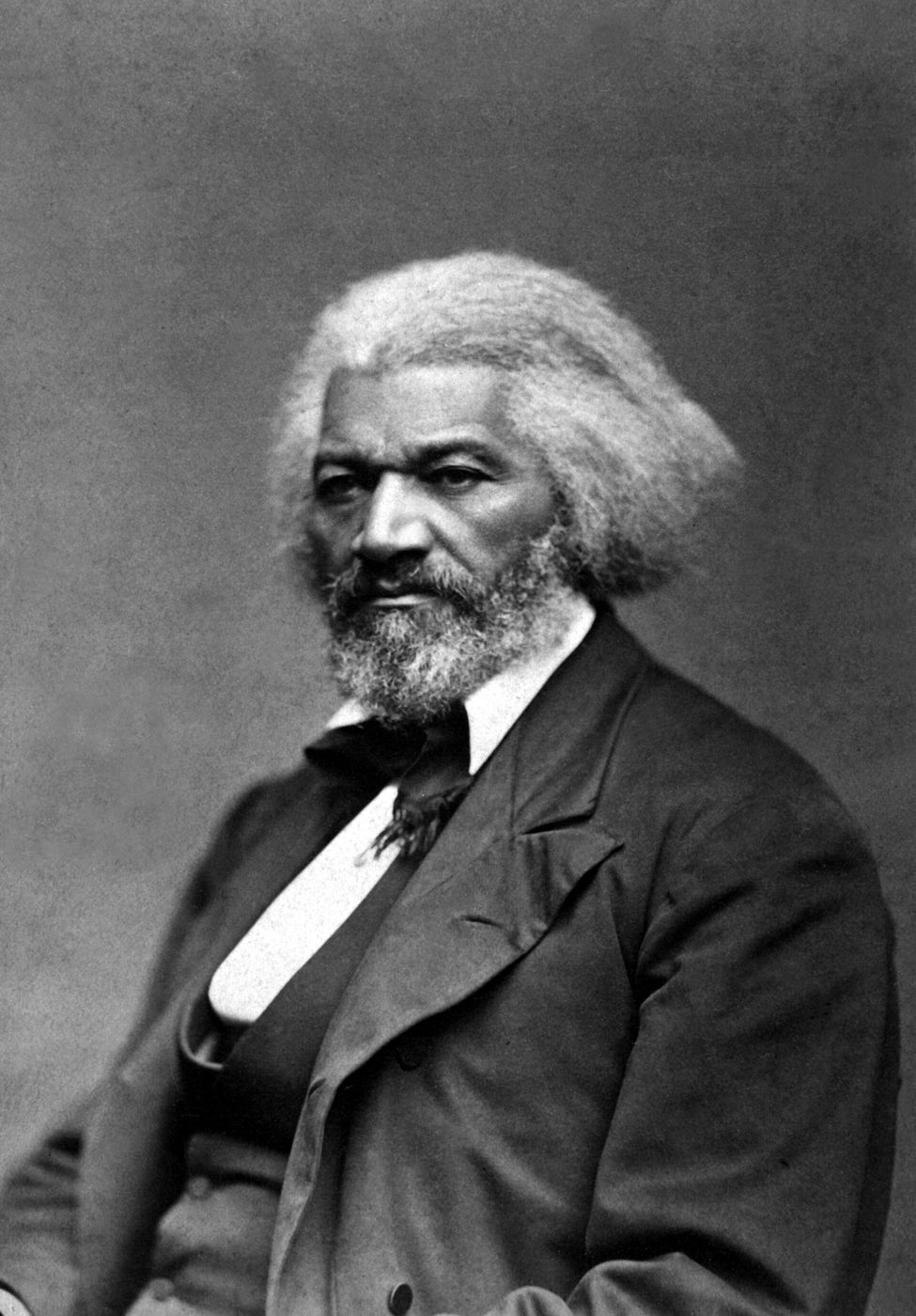 Photograph of Frederick Douglass in his sixties, seated, with white hair and a dark suit