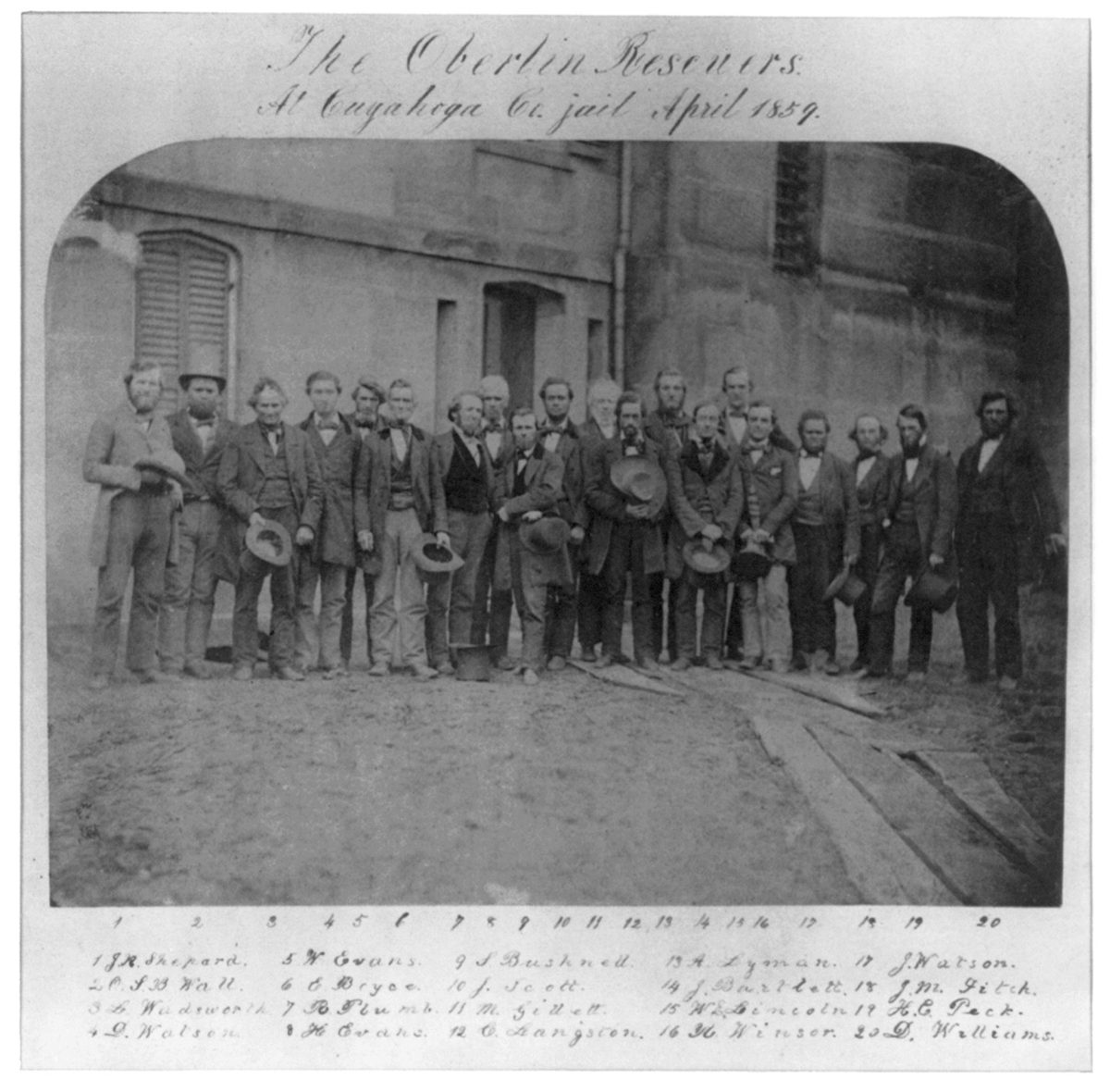 Photograph of a group of men posed together at the Cuyahoga County jail in Cleveland in 1859
