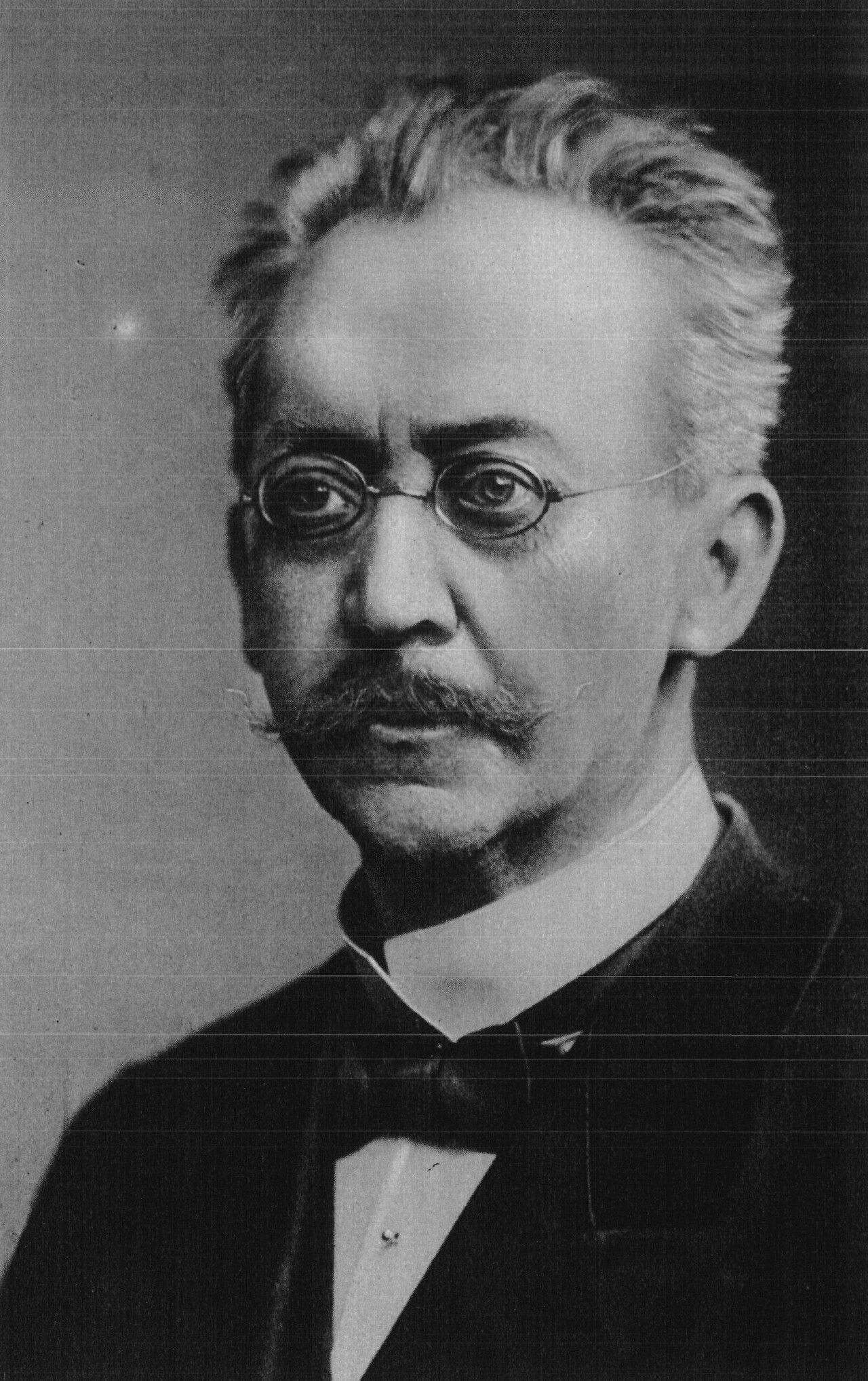 Black and white portrait photograph of Adolf von Harnack, an older man with a mustache and high forehead