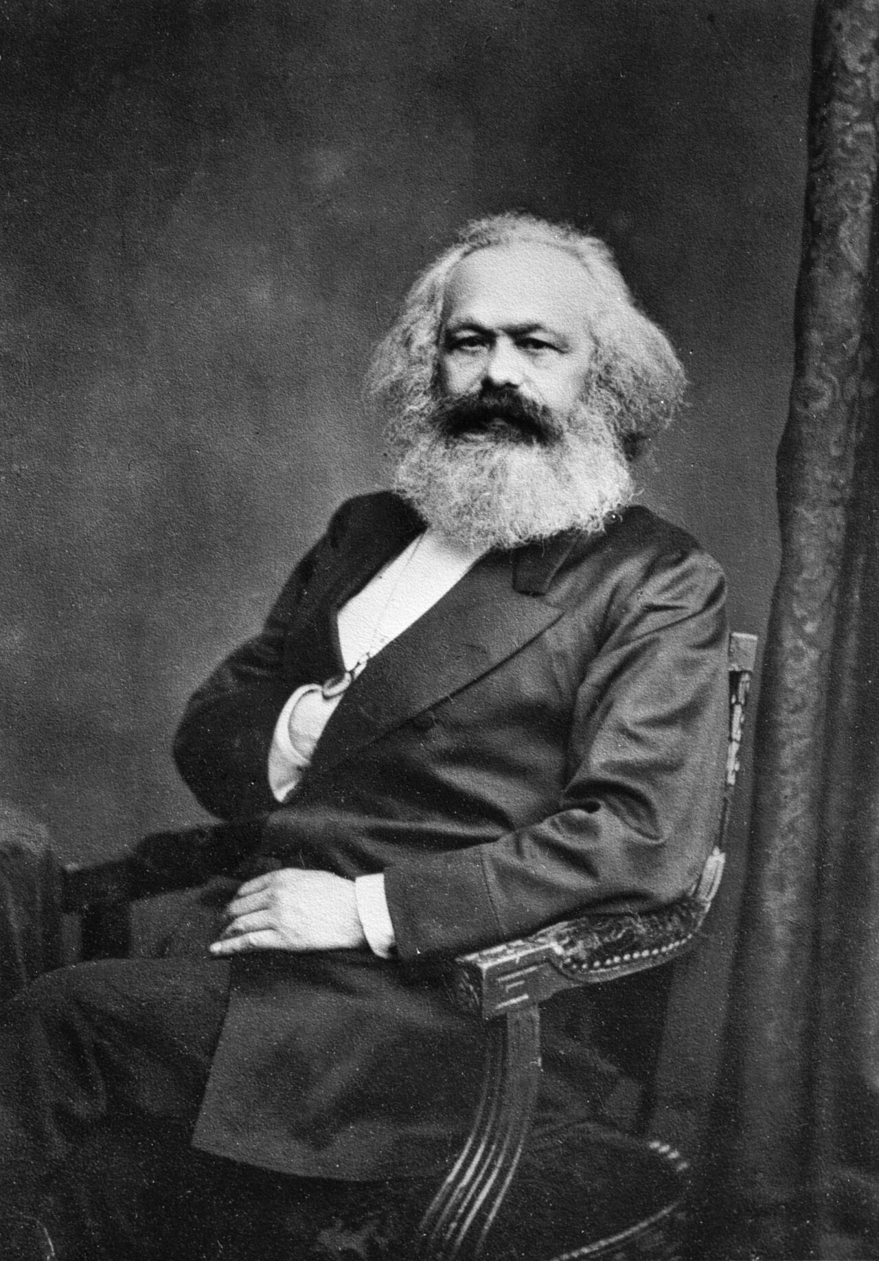 Photograph of Karl Marx with a full beard and thick hair
