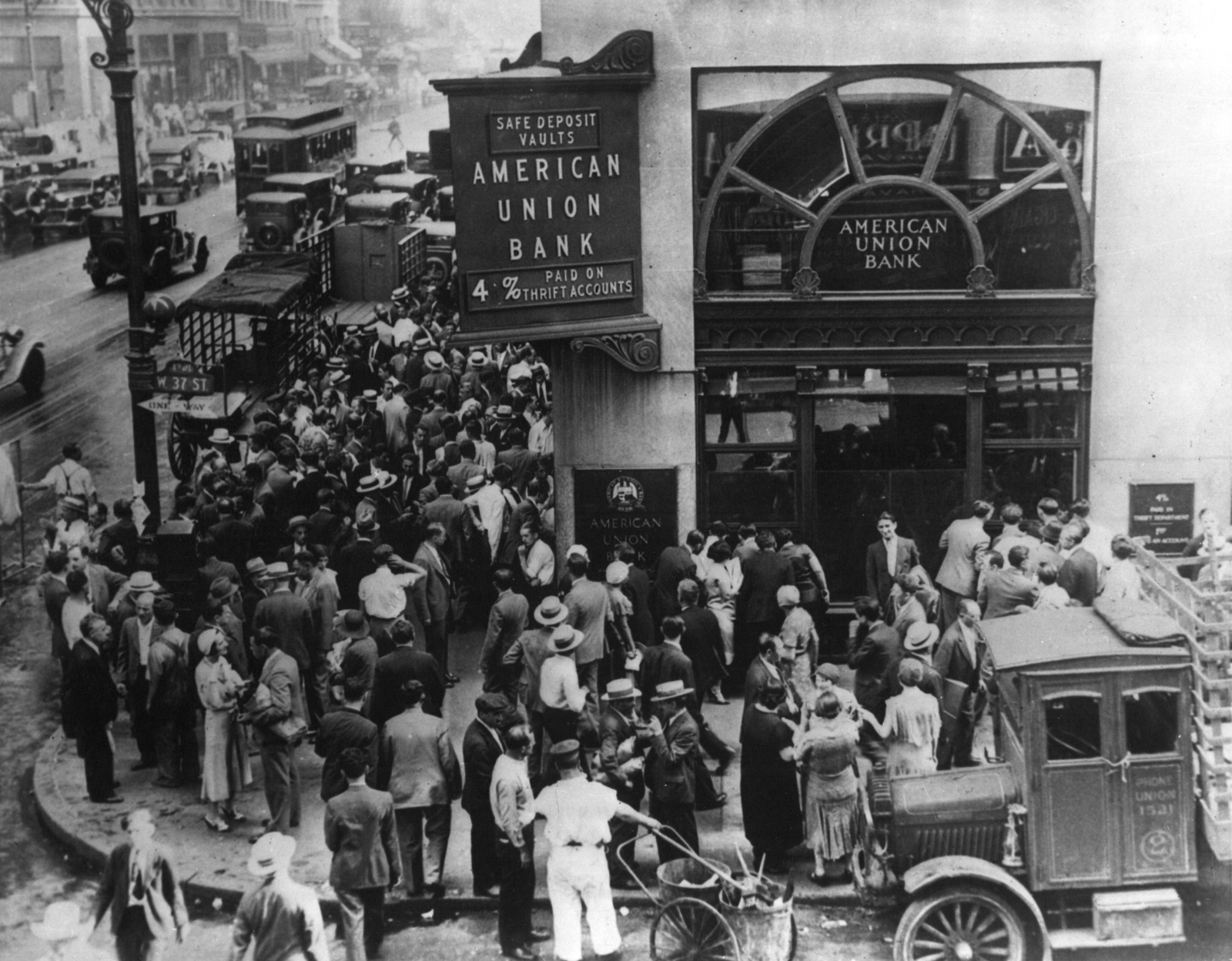 A large crowd of people gathered in the street outside the American Union Bank in New York during a bank run