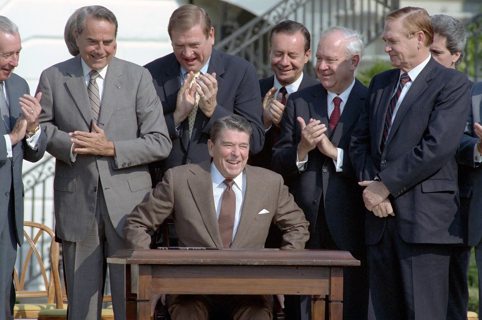 President Reagan signing the Tax Reform Act of 1986 on the White House South Lawn with members of Congress present