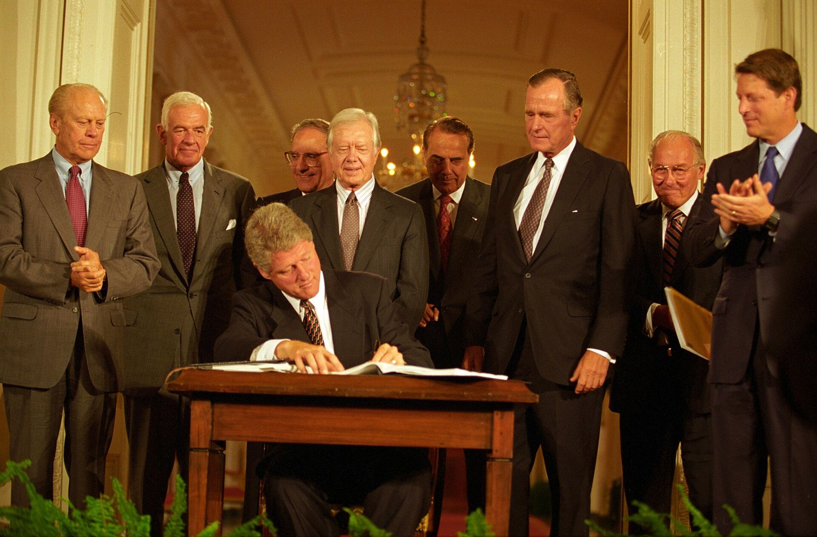 President Bill Clinton signing the NAFTA side agreements in the East Room of the White House, joined by former Presidents Bush, Carter and Ford