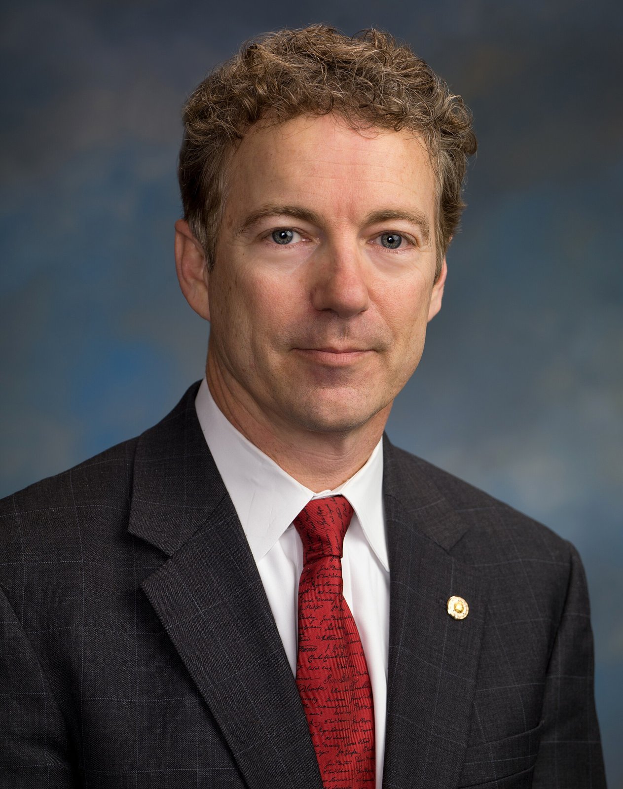 Official Senate portrait of Senator Rand Paul in a dark suit in front of an American flag