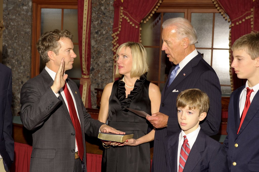 Vice President Joe Biden administers a ceremonial oath to Rand Paul, who raises his right hand while his wife Kelley and their three sons stand beside him