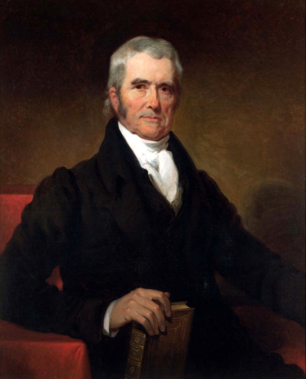 Painted portrait of John Marshall in old age, seated in a black coat in a red chair, with gray hair, one hand resting on a book