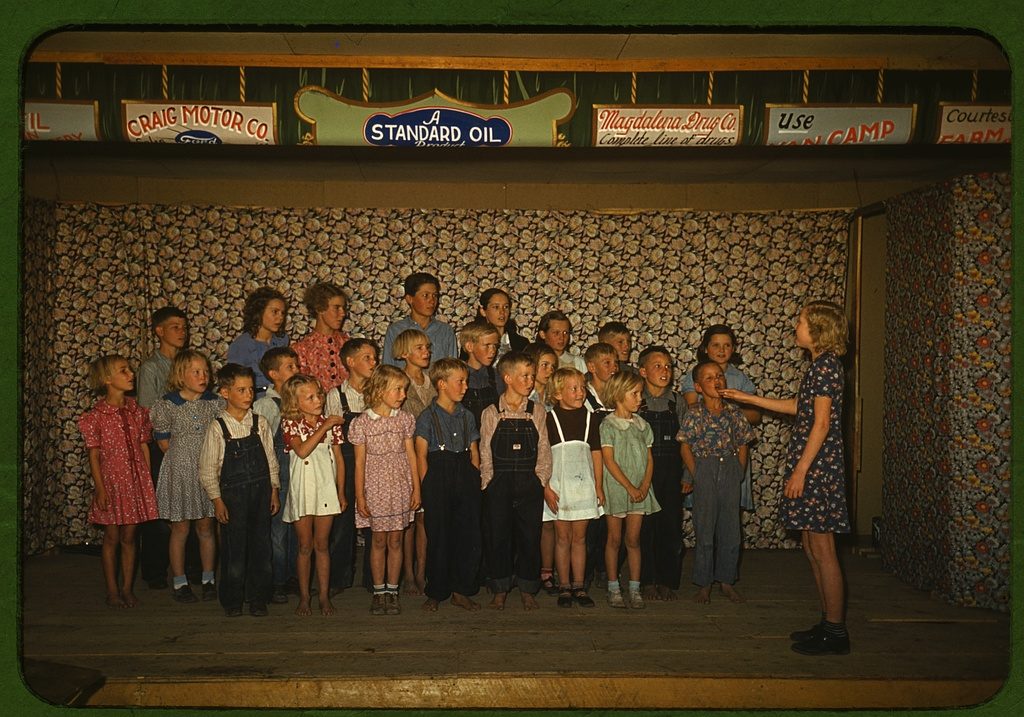 Color photograph of school children singing together in Pie Town, New Mexico, in 1940